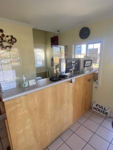 a kitchen with a counter and a clock on the wall at North Bay Inn Santa Rosa in Santa Rosa