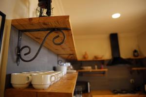 a group of cups on a counter in a kitchen at Wings of Tatev Private Villa in Halidzor