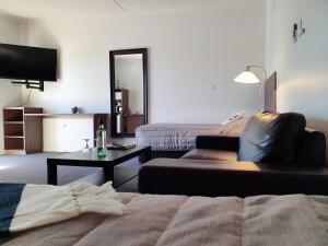 a living room with a bed and a couch at Motel Riverbend in Tailem Bend