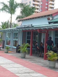 a restaurant with people sitting in chairs outside of it at Towers by the Beach in Ocho Rios