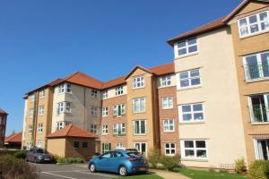 a apartment building with a blue car parked in front at Entire Duplex apartment for up to 6 guests, free wifi in Darlington