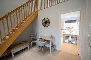 a dining room with a table and a wooden staircase at Entire Duplex apartment for up to 6 guests, free wifi in Darlington