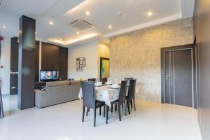 a dining room with a table and chairs at Honeybee Pool Villa Smooth as Silk in Ao Nang Beach