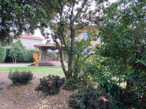 a tree in the yard of a house at Villa Adriana Tuscia Country Retreat in Vetralla