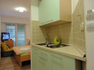 a kitchen with a sink and a counter top at Accommodation Mell in Ohrid