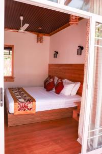 Ένα ή περισσότερα κρεβάτια σε δωμάτιο στο New Breeze Thoddoo Inn