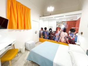 a bedroom with a bed and a painting of kids at BaRock B&B Palermo in Palermo