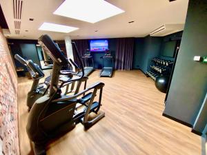 a gym with treadmills and machines in a room at Chlebova Apartments in Gdańsk