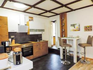 a kitchen with a stove and a counter top at Ferienwohnung Zur Backstube in Tanne