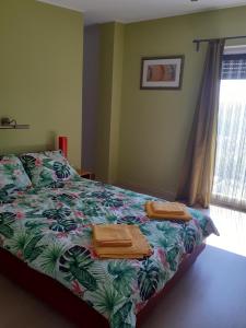 a bedroom with a bed with towels on it at Banat Residence in Reşiţa
