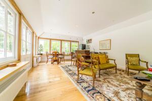 a living room with a table and chairs at Molland Manor House Self catering (10 bedrooms 9 bathrooms) in Sandwich