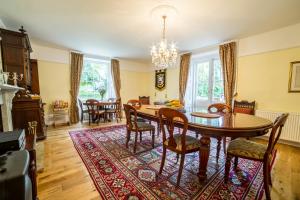 a dining room with a table and chairs at Molland Manor House Self catering (10 bedrooms 9 bathrooms) in Sandwich