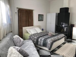 a living room with a bed and a couch at La Villa - Beach house & Rooms in Crikvenica