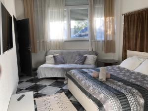 a living room with two beds and a couch at La Villa - Beach house & Rooms in Crikvenica