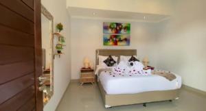 a bedroom with a bed with white sheets and pillows at Villa Akmali Canggu - 2 Bedrooms in Canggu +24 photos
