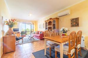 a living room with a wooden table and chairs at Apartment Buena Vista in Cala Santanyi