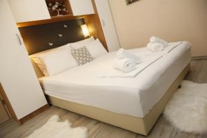 a bed in a small room with towels on it at Apartment Tina in Vodice