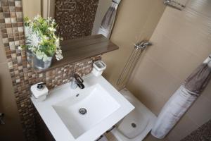 a bathroom with a white sink and a toilet at Apartment Tina in Vodice +30 photos