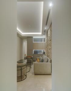 a living room with a couch and a table at Apartamentos Los Patios del Pañuelo in Córdoba