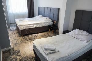 two beds in a hotel room with two bedsvisor at Hotel Nafta Krosno in Krosno