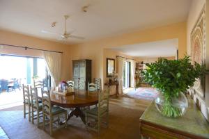 a dining room with a wooden table and chairs at Las Ranas CASASOLA BEACH & GOLF VILLA in Estepona