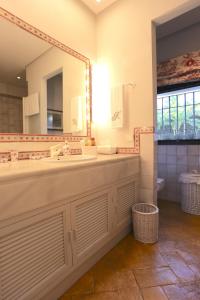 a bathroom with a large mirror and a sink at Las Ranas CASASOLA BEACH & GOLF VILLA in Estepona