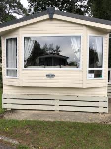 a large window on the side of a house at Oakdene Forest Park Violet 1 in Saint Leonards