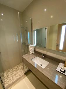 a bathroom with a sink and a mirror at Aram Hotel - AlMeshael Exit 18 in Riyadh