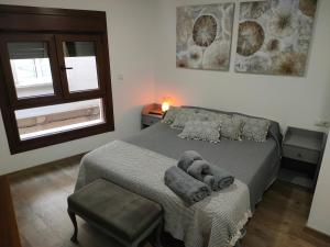 a bedroom with a bed with a stuffed animal on it at A Casa das Burgas in Cuntis