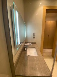 a bathroom with a sink and a mirror at Aram Hotel - AlMeshael Exit 18 in Riyadh