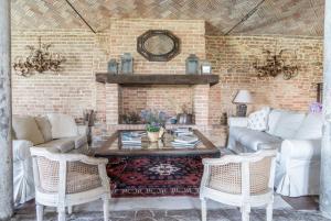 a living room with a couch and a table and chairs at Villa Ca de Poi - Tabiano Castle Country Villas in Salsomaggiore Terme