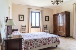 a bedroom with a bed and a dresser and a window at Villa Ca de Poi - Tabiano Castle Country Villas in Salsomaggiore Terme +35 photos