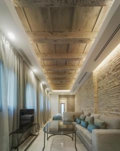 a living room with a couch and a table at Apartamentos Los Patios del Pañuelo in Córdoba