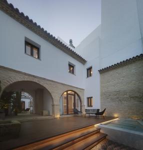 an external view of a house with a wooden deck at Apartamentos Los Patios del Pañuelo in Córdoba