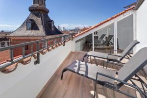 a balcony with two chairs and a roof at B&B HOTEL Madrid Centro Plaza Mayor in Madrid
