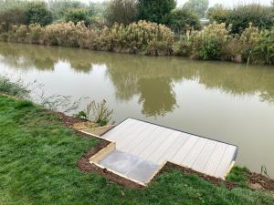 a dock in the middle of a body of water at Chapel Fields Holiday Park in Chapel Saint Leonards
