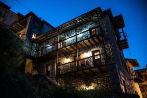 an old building with lights on at night at Despotikon Dimitsana Guest house - Ξενώνας Δεσποτικόν Αντωνόπουλου in Dhimitsana