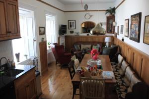 a kitchen and a living room with a table at Johnston House: Historic Village Retreat in Kinvara