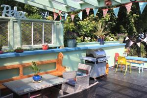 a patio with a grill and a table and chairs at Johnston House: Historic Village Retreat in Kinvara