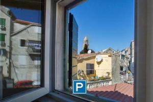 a window with a view of a city at Authentic Luxury Rooms in Split