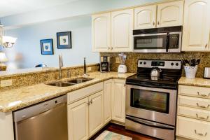 a kitchen with white cabinets and stainless steel appliances at Wild Dunes Resort - Vacation Rentals in Isle of Palms