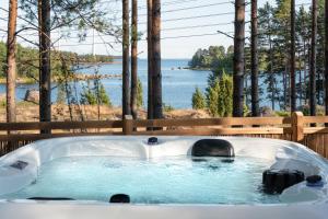 a bath tub with a view of the water at Santalahti Resort Cottages & Villas in Kotka