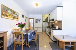 a kitchen and dining room with a table and chairs at Apartment Tija in Dubrovnik