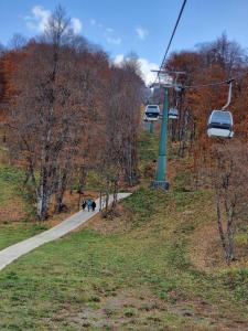 a gondola ride in a park with people walking down a path at Crystal Hotel & SPA in Bakuriani