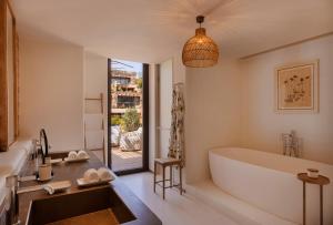 a bathroom with a tub and a sink at Six Senses Ibiza in Portinatx