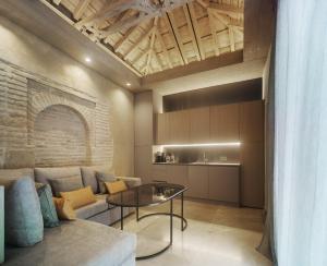 a living room with a couch and a table at Apartamentos Los Patios del Pañuelo in Córdoba