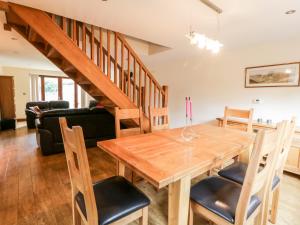 a dining room with a wooden table and chairs at Grange View in Ripon