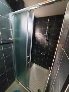 a shower with a glass door in a bathroom at Anna Guesthouse 10 min walk from the beach in Larnaca