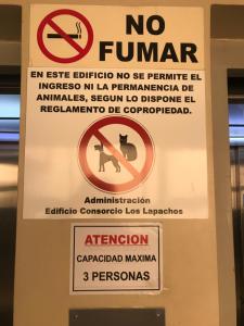 a sign on a door that reads no fan and no permit at Departamentos Belgrano in Salta