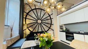 a living room with a table with a vase of flowers at Design-Apartments Am Kaisersaal in Erfurt